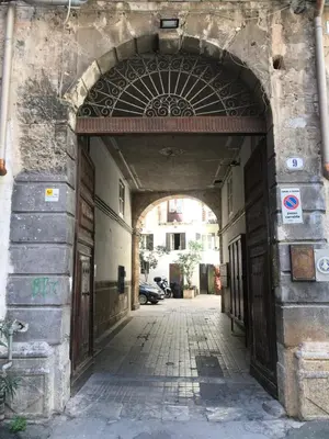 an entrance to a building with an archway at La Fabbrica del Viceré in Palermo