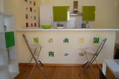a kitchen with two chairs and green cabinets at La Fabbrica del Viceré in Palermo