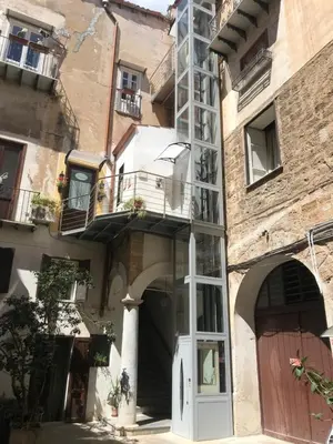 a building with a door and a balcony at La Fabbrica del Viceré in Palermo