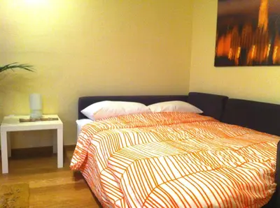 a bedroom with a bed and a table with a lamp at La Fabbrica del Viceré in Palermo