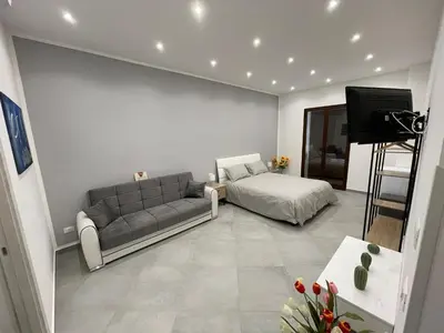 a living room with a couch and a bed at Baron’s Suites in Palermo