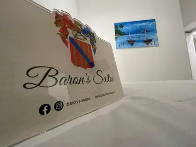 a sign for a restaurant with a boat on the wall at Baron’s Suites in Palermo