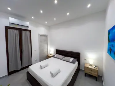 a bedroom with a bed with two pillows on it at Baron’s Suites in Palermo