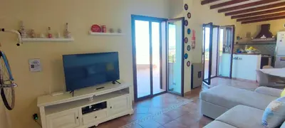 a living room with a flat screen tv on a stand at Villa Belvedere di Altavilla with Pool and Near The Sea in Altavilla Milicia