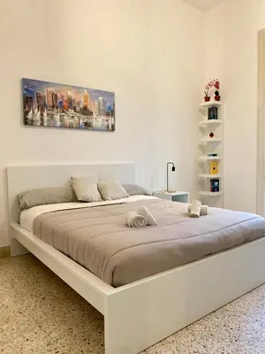 a white bedroom with a large white bed in it at Urban poet retreat - casa di vincenzo e andrea 2 in Palermo