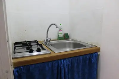 a kitchen counter with a sink and a stove at La Melagrana in Castellammare del Golfo
