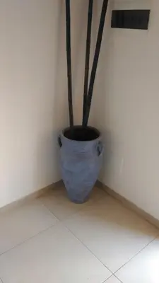 a blue vase sitting in a corner of a room at La Melagrana in Castellammare del Golfo