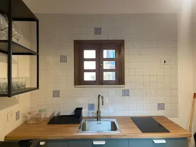 a kitchen counter with a sink and a window at Cortile Cascino Home in Palermo