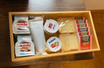 a lunch box with different types of bread at Cortile Cascino Home in Palermo