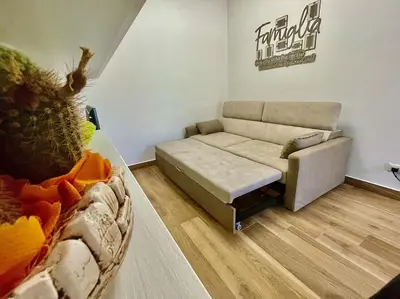 a living room with a couch and a table at Sicilian Shore Haven, 2 min to SEA in Terrasini