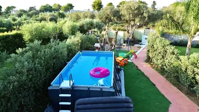 a swimming pool with a pink frisbee in it at Sicilian Shore Haven, 2 min to SEA in Terrasini