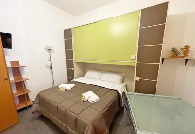 a bedroom with a bed with two towels on it at Monfenera Little Apartments in Palermo