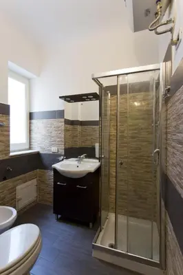 a bathroom with a shower and a sink and a toilet at Monfenera Little Apartments in Palermo