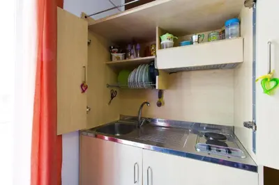 a small kitchen with a sink and a stove at Monfenera Little Apartments in Palermo
