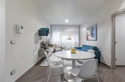 a living room with a white table and chairs at GuestHost - Al Qasr Design and Luxury Flat - Palermo Center in Palermo