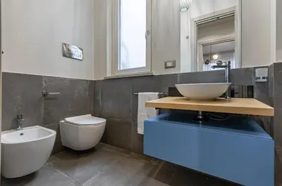 a bathroom with a sink and a toilet at GuestHost - Al Qasr Design and Luxury Flat - Palermo Center in Palermo
