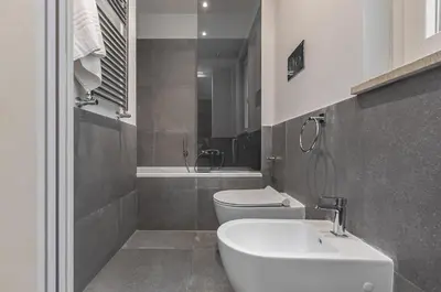 a bathroom with a sink and a toilet and a tub at GuestHost - Al Qasr Design and Luxury Flat - Palermo Center in Palermo