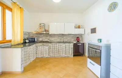 a kitchen with white cabinets and a counter top at 2 Bedroom Amazing Home In Trabia in Trabia