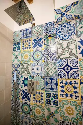 a bathroom with blue and white tiles on the wall at La Terrazza Sullo Spasimo in Palermo