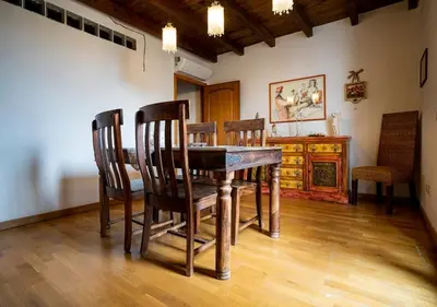a dining room with a wooden table and chairs at La Terrazza Sullo Spasimo in Palermo