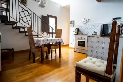 a kitchen and dining room with a table and chairs at La Terrazza Sullo Spasimo in Palermo