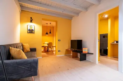 a living room with a couch and a tv at LEGO36 Apartment in Palermo