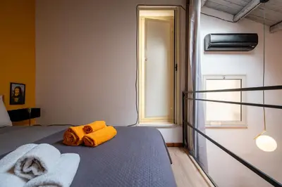 a bedroom with a bed with towels on it at LEGO36 Apartment in Palermo