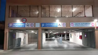 an empty parking garage with signs on the side of a building at Casa Doriana in Palermo