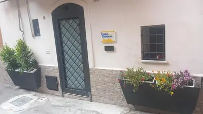 a door of a building with flowers and plants at Casa Doriana in Palermo