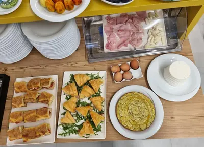 a table with plates of food and bowls of food at Hotel Arte Mare - camere in via del mulino 45 in San Vito lo Capo