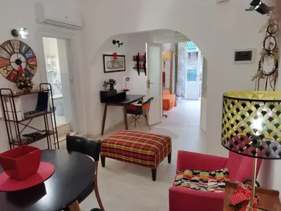 a living room with a table and a dining room at The tailor's house in Palermo