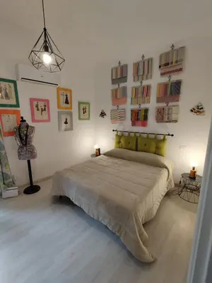 a bedroom with a large bed in a room at The tailor's house in Palermo