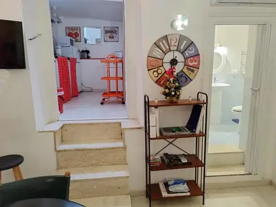 a room with a clock on the wall and a staircase at The tailor's house in Palermo