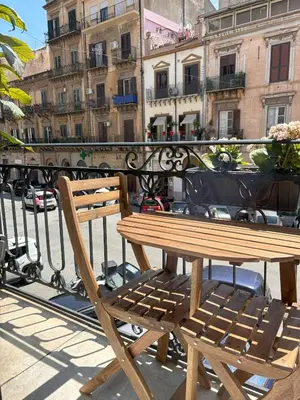 a wooden bench sitting on top of a balcony at Olivuzza 27 in Palermo