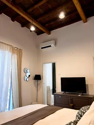 a bedroom with a bed and a flat screen tv at Olivuzza 27 in Palermo