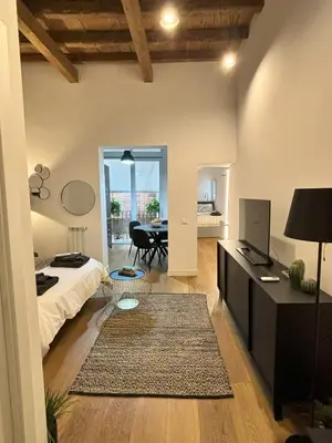 a bedroom with a bed and a table in a room at Olivuzza 27 in Palermo