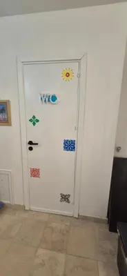 a white door with stickers on it in a room at NONNA ADRIANA in Terrasini