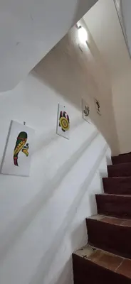 a staircase with some pictures on the wall at NONNA ADRIANA in Terrasini