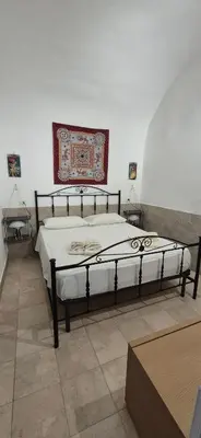 a bedroom with a bed in a room at NONNA ADRIANA in Terrasini