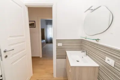 a bathroom with a sink and a mirror at LE TRE CHIAVI Apartment in Palermo