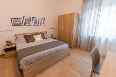 a bedroom with a bed and a desk and a table at LE TRE CHIAVI Apartment in Palermo