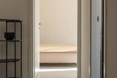 a sliding glass door leading to a bedroom with a bed at Casa M al Teatro Massimo in Palermo