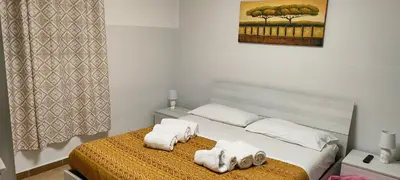 a bedroom with a bed with towels on it at Sicily guest house in Palermo