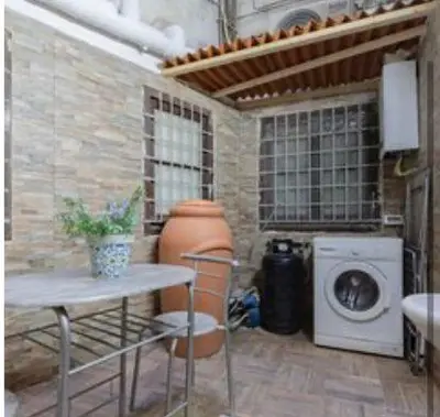 a kitchen with a washing machine and a washer at Sicily guest house in Palermo