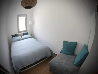 a small bedroom with a bed and a window at Appartamento nel centro storico di Palermo in Palermo