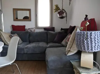 a living room with a gray couch and a table at Appartamento nel centro storico di Palermo in Palermo
