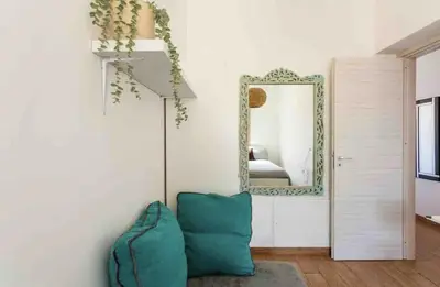 a room with a mirror and a green pillow at Appartamento nel centro storico di Palermo in Palermo