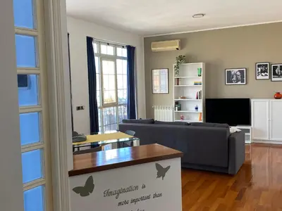 a living room with a couch and a table at MaDà holiday house ideale per coppie o famiglie in Palermo