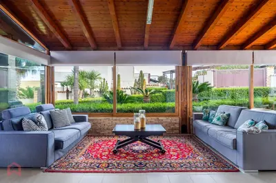 a living room with two couches and a table at Villa vista mare e piscina privata ad Alcamo in Alcamo