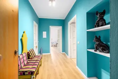 a living room with blue walls and a couch at Verosicily Sant'Elia suite in Palermo